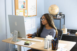 international student office worker on a computer